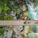 斯洛文尼亚索奇河上的木制吊桥上骑自行车的人的鸟瞰图 (© Amazing Aerial Agency/Offset by Shutterstock)(20210603)